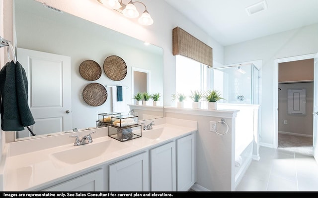 507 Sacred Fig Ln, Crosby, TX 77532 - bathroom featuring an enclosed shower, tile patterned floors, double vanity, baseboards, and a tub