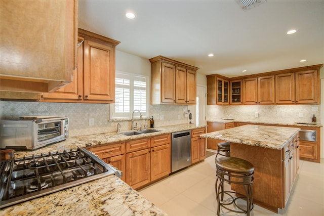 14227 Indian Wells Dr, Houston, TX 77069 - kitchen featuring stainless steel dishwasher, a sink, brown cabinetry, range, and light stone counters