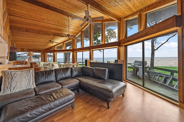 living area featuring wooden ceiling, a ceiling fan, beamed ceiling, wood finished floors, and high vaulted ceiling