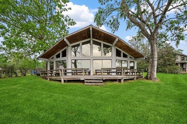 exterior space featuring a deck and a lawn