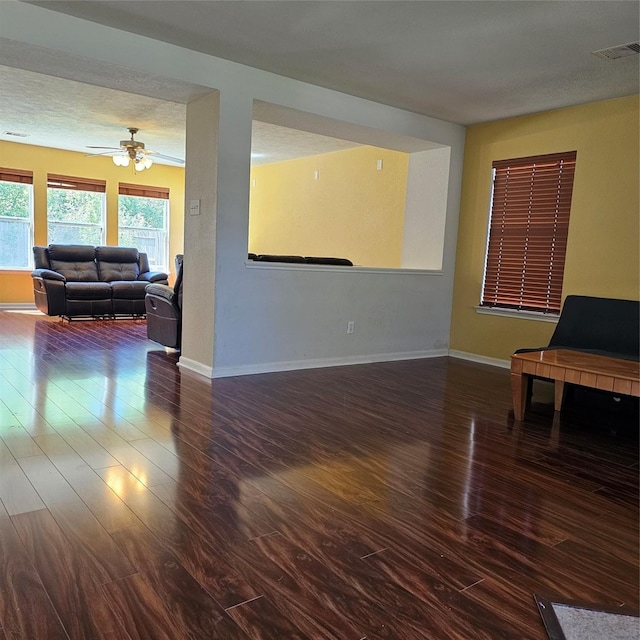 11727 Madison Oak St, Houston, TX 77038 - living room with baseboards, a textured ceiling, visible vents, ceiling fan, and wood finished floors