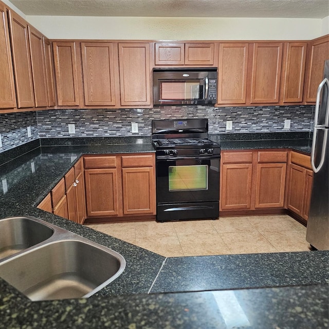11727 Madison Oak St, Houston, TX 77038 - kitchen featuring brown cabinetry, tasteful backsplash, a textured ceiling, black appliances, and light tile patterned flooring