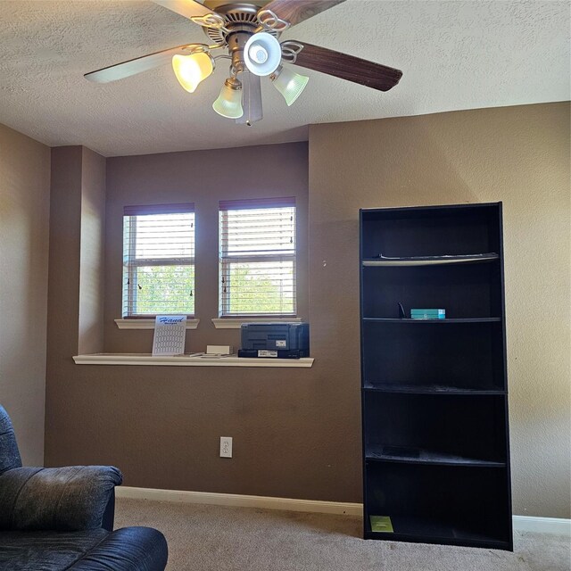 11727 Madison Oak St, Houston, TX 77038 - sitting room featuring a textured ceiling, ceiling fan, baseboards, and carpet floors