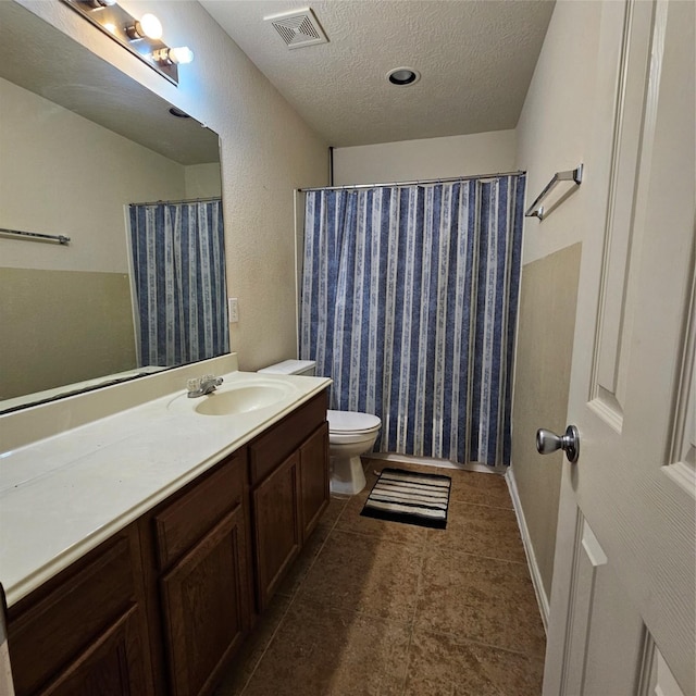 11727 Madison Oak St, Houston, TX 77038 - bathroom with vanity, tile patterned flooring, a textured ceiling, toilet, and visible vents
