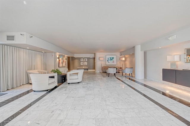 living area with visible vents and marble finish floor