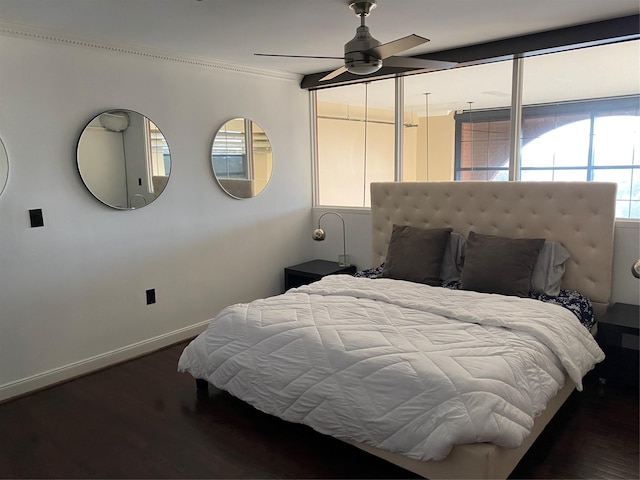 bedroom featuring crown molding, a ceiling fan, baseboards, and wood finished floors