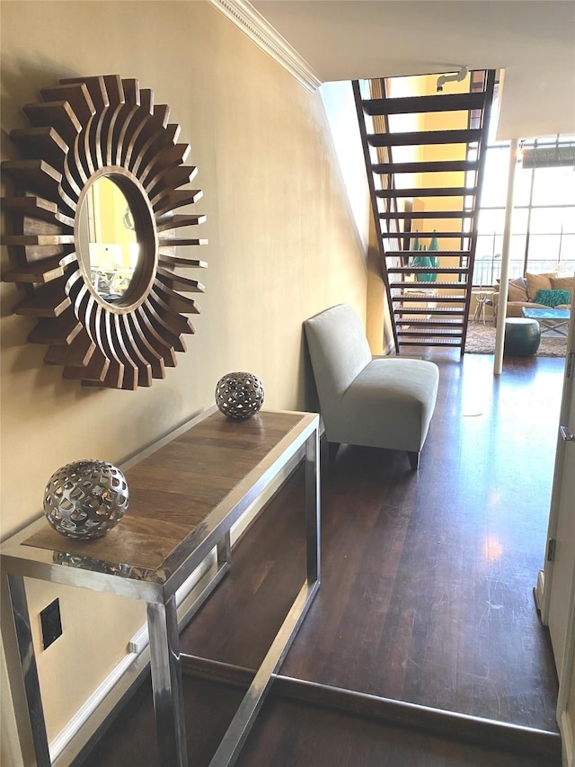 interior space featuring ornamental molding, wood finished floors, and stairway
