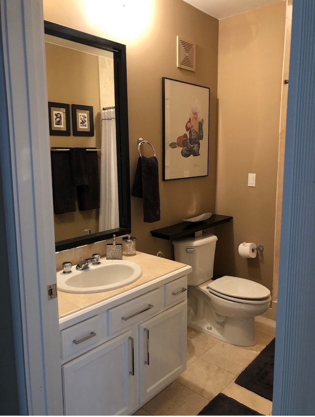 bathroom featuring vanity, tile patterned floors, visible vents, and toilet
