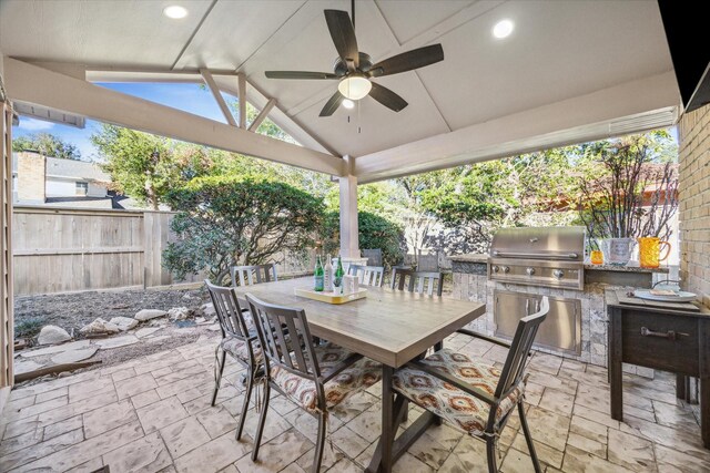 view of patio / terrace with a grill, exterior kitchen, outdoor dining space, a ceiling fan, and a fenced backyard