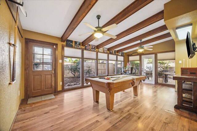 playroom featuring ceiling fan, a textured wall, light wood finished floors, pool table, and vaulted ceiling with beams
