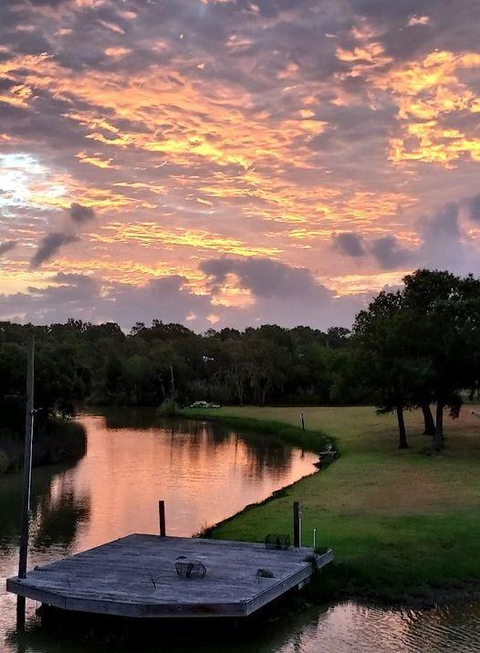 603 Shady Glen Dr, Anahuac, TX 77514 - dock area with a water view and a wooded view