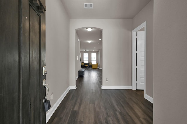 17052 Easter Lily Dr, Conroe, TX 77385 - entrance foyer featuring arched walkways, dark wood-style floors, and baseboards