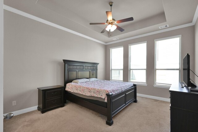 17052 Easter Lily Dr, Conroe, TX 77385 - bedroom featuring a raised ceiling, light carpet, multiple windows, and crown molding