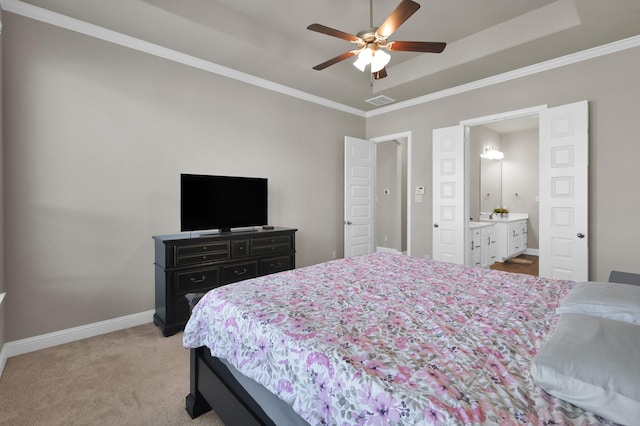 17052 Easter Lily Dr, Conroe, TX 77385 - bedroom featuring baseboards, ornamental molding, light carpet, a tray ceiling, and ensuite bathroom