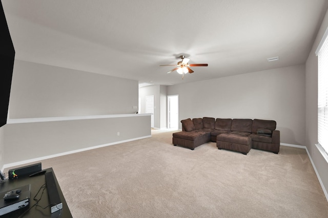 17052 Easter Lily Dr, Conroe, TX 77385 - carpeted living room with ceiling fan and baseboards