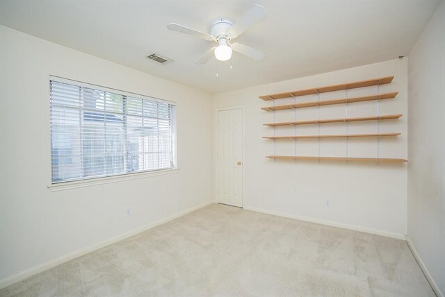 23006 Greenrush Dr, Katy, TX 77494 - unfurnished room featuring light colored carpet, baseboards, a ceiling fan, and visible vents
