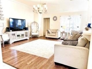 23006 Greenrush Dr, Katy, TX 77494 - living room with an inviting chandelier and wood finished floors