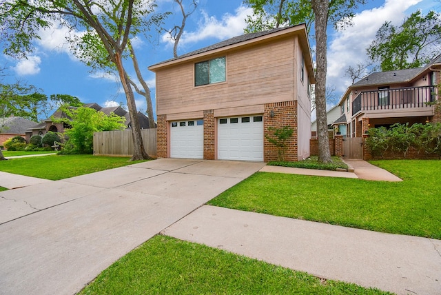 view of front of house featuring an attached garage, concrete driveway, a front yard, and fence