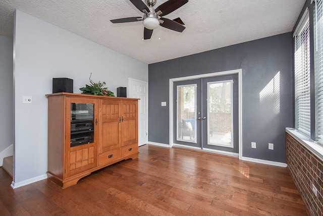 interior space featuring plenty of natural light, wood-type flooring, and french doors