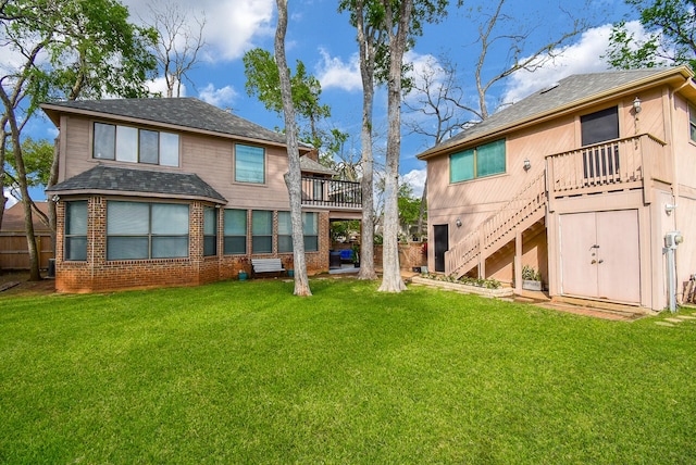 back of property with a lawn and stairway