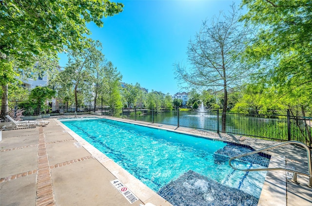 pool with a patio area and fence