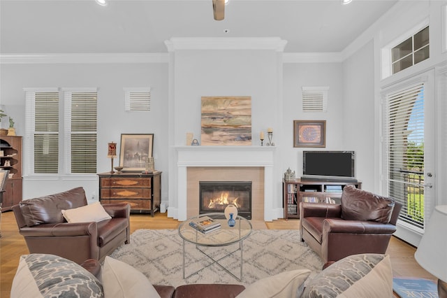 living room with ornamental molding and wood finished floors