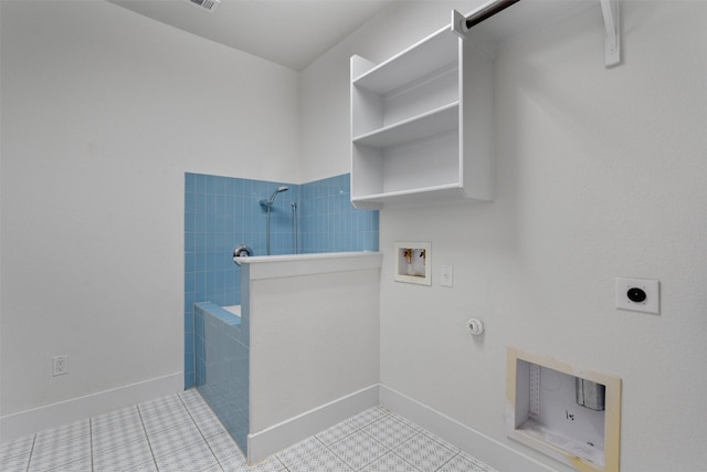 clothes washing area with laundry area, hookup for a washing machine, electric dryer hookup, gas dryer hookup, and baseboards
