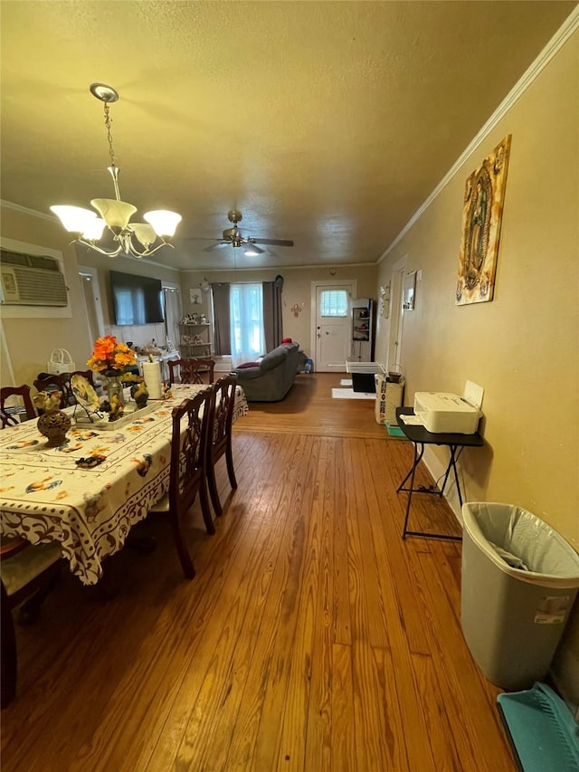 406 W Liberty Rd, Harleton, TX 75651 - dining room with crown molding, a textured ceiling, a wall unit AC, and wood-type flooring