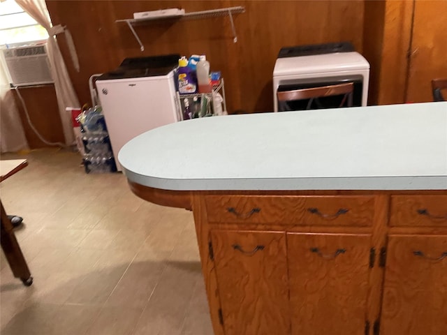 406 W Liberty Rd, Harleton, TX 75651 - kitchen with brown cabinets, cooling unit, light countertops, and refrigerator