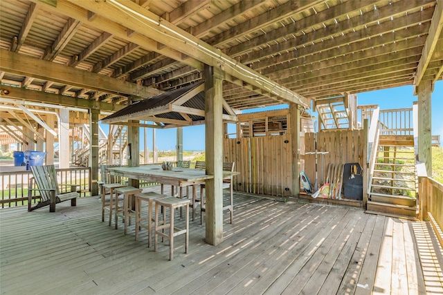 deck with outdoor dining space and stairs