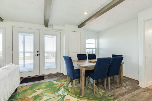 dining area with french doors, wood finished floors, and beam ceiling