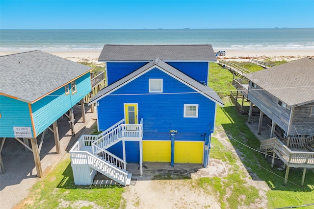 bird's eye view with a water view and a beach view