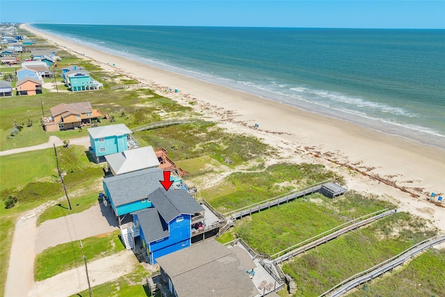 drone / aerial view featuring a view of the beach and a water view