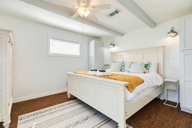 bedroom featuring visible vents, baseboards, dark wood-style flooring, a ceiling fan, and beamed ceiling
