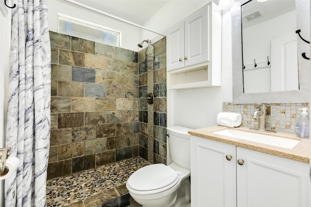 full bathroom with backsplash, toilet, tiled shower, and vanity