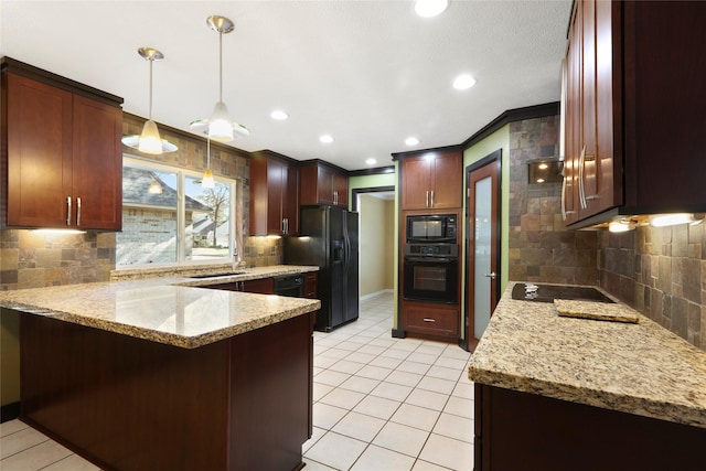 2327 Brookdale Dr, Kingwood, TX 77339 - kitchen featuring black appliances, a peninsula, tasteful backsplash, light stone counters, and hanging light fixtures