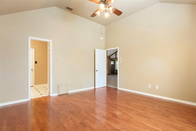 2327 Brookdale Dr, Kingwood, TX 77339 - empty room with ceiling fan, high vaulted ceiling, light wood-style floors, and baseboards
