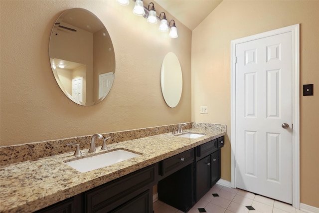 2327 Brookdale Dr, Kingwood, TX 77339 - full bathroom with double vanity, lofted ceiling, tile patterned flooring, and baseboards