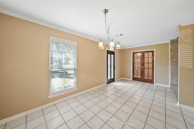 2327 Brookdale Dr, Kingwood, TX 77339 - unfurnished room featuring ornamental molding, french doors, a chandelier, baseboards, and light tile patterned floors