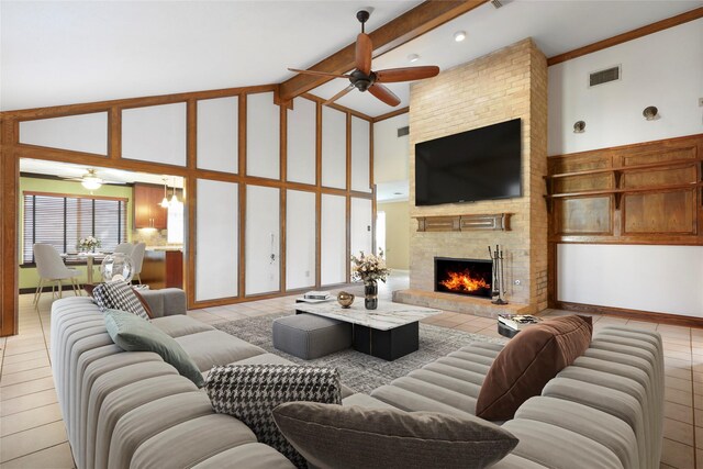 2327 Brookdale Dr, Kingwood, TX 77339 - living room featuring a ceiling fan, high vaulted ceiling, tile patterned floors, a fireplace, and beamed ceiling