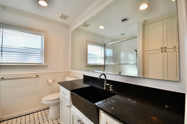 5718 Benning Dr, Houston, TX 77096 - bathroom featuring a shower stall, healthy amount of natural light, toilet, vanity, and a wainscoted wall