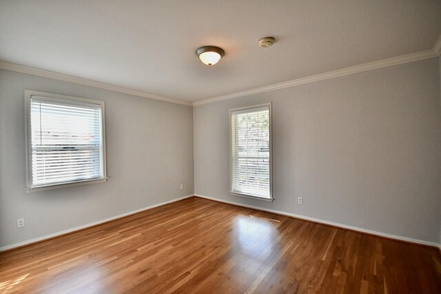 5718 Benning Dr, Houston, TX 77096 - spare room with healthy amount of natural light, wood finished floors, crown molding, baseboards, and a smoke detector