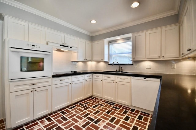 5718 Benning Dr, Houston, TX 77096 - kitchen featuring white appliances, a sink, brick floors, under cabinet range hood, and dark countertops
