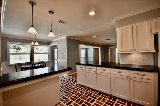 5718 Benning Dr, Houston, TX 77096 - kitchen with brick flooring, white cabinets, dark countertops, backsplash, and ornamental molding