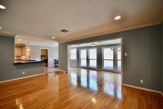 5718 Benning Dr, Houston, TX 77096 - unfurnished living room featuring crown molding, baseboards, light wood-style flooring, and recessed lighting