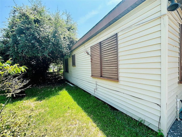 view of property exterior with a lawn