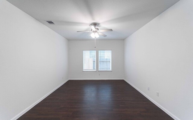 3109 Aqua Wave Dr, Texas City, TX 77568 - empty room featuring dark wood-style flooring, ceiling fan, and baseboards