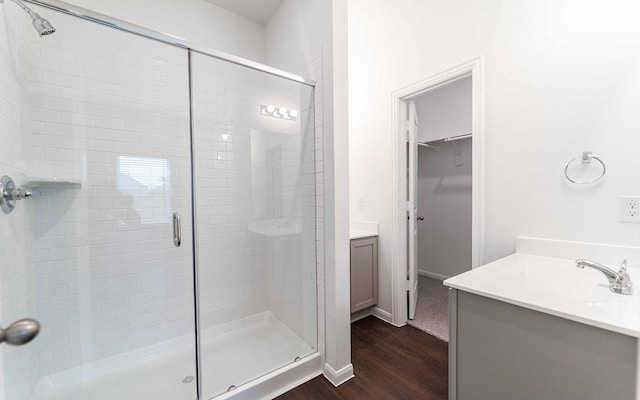 3109 Aqua Wave Dr, Texas City, TX 77568 - full bathroom with vanity, wood finished floors, a shower stall, a walk in closet, and baseboards