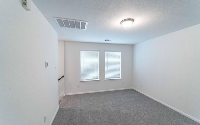3109 Aqua Wave Dr, Texas City, TX 77568 - carpeted spare room with a textured ceiling and baseboards