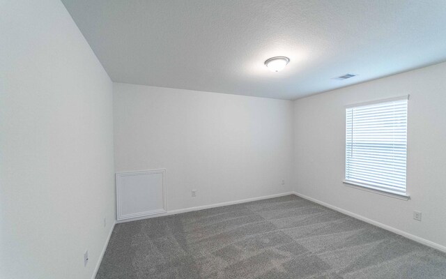 3109 Aqua Wave Dr, Texas City, TX 77568 - carpeted spare room featuring baseboards and a textured ceiling